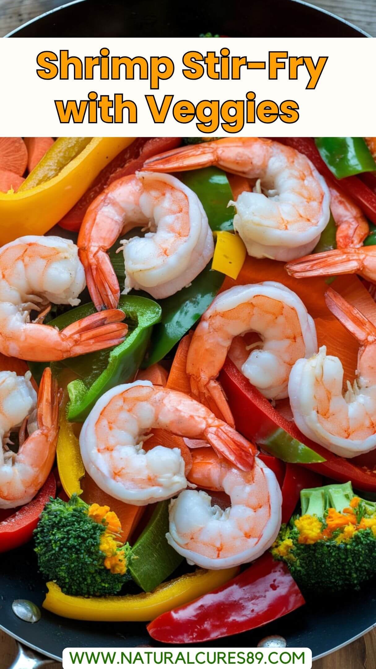 A photo of a quick shrimp stir-fry with vegetables. There are large shrimp in a pan with sliced bell peppers, broccoli, and carrots. The shrimp are pink and the vegetables are bright in color. The background is a wooden surface.